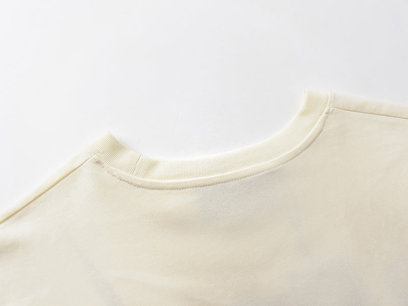 Cream crew-neck T-shirt neckline detail with ribbed collar