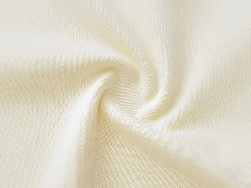 Cream T-shirt fabric close-up showing soft knit texture