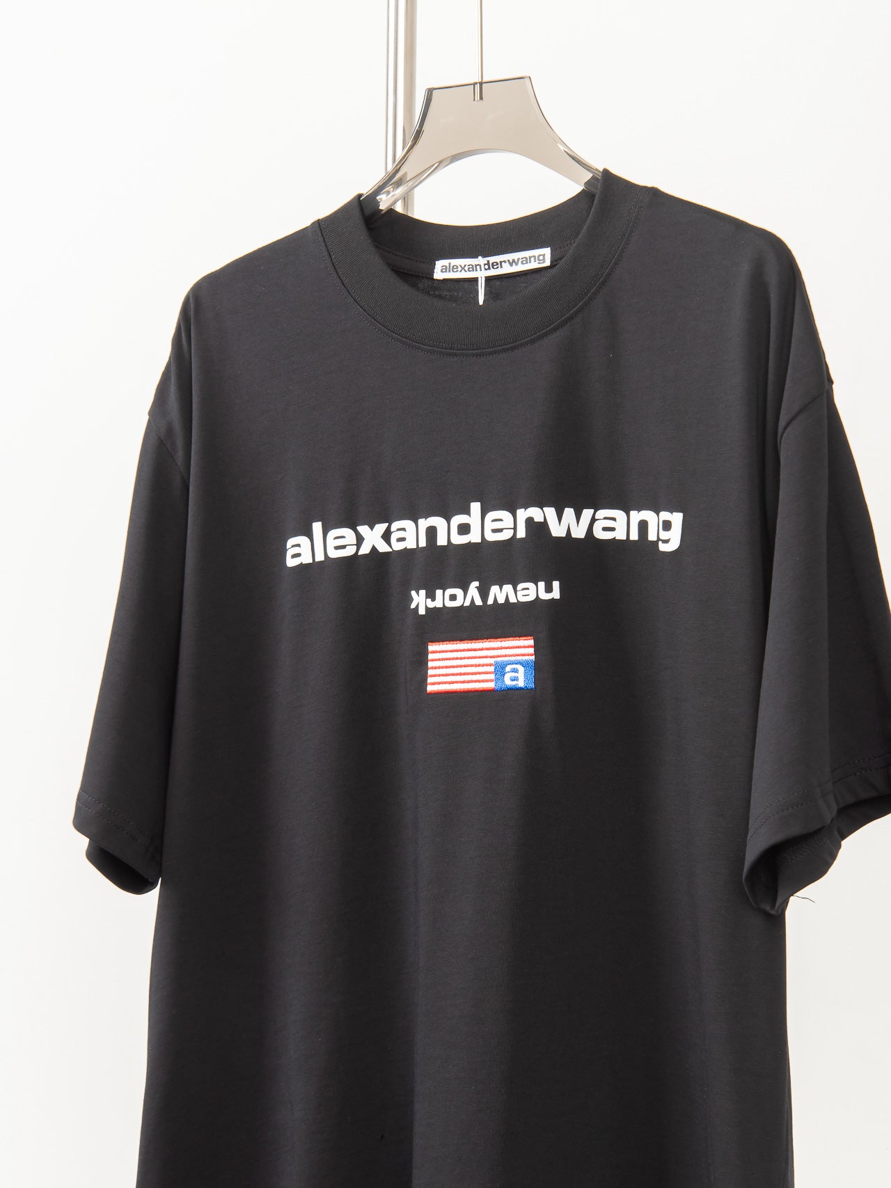 Black short-sleeve T-shirt with large alexanderwang logo and flag-style graphic