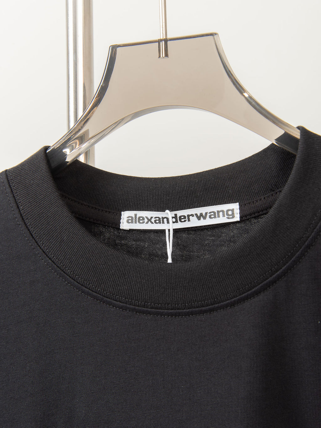 Black crew-neck T-shirt collar with alexanderwang brand label inside neckline