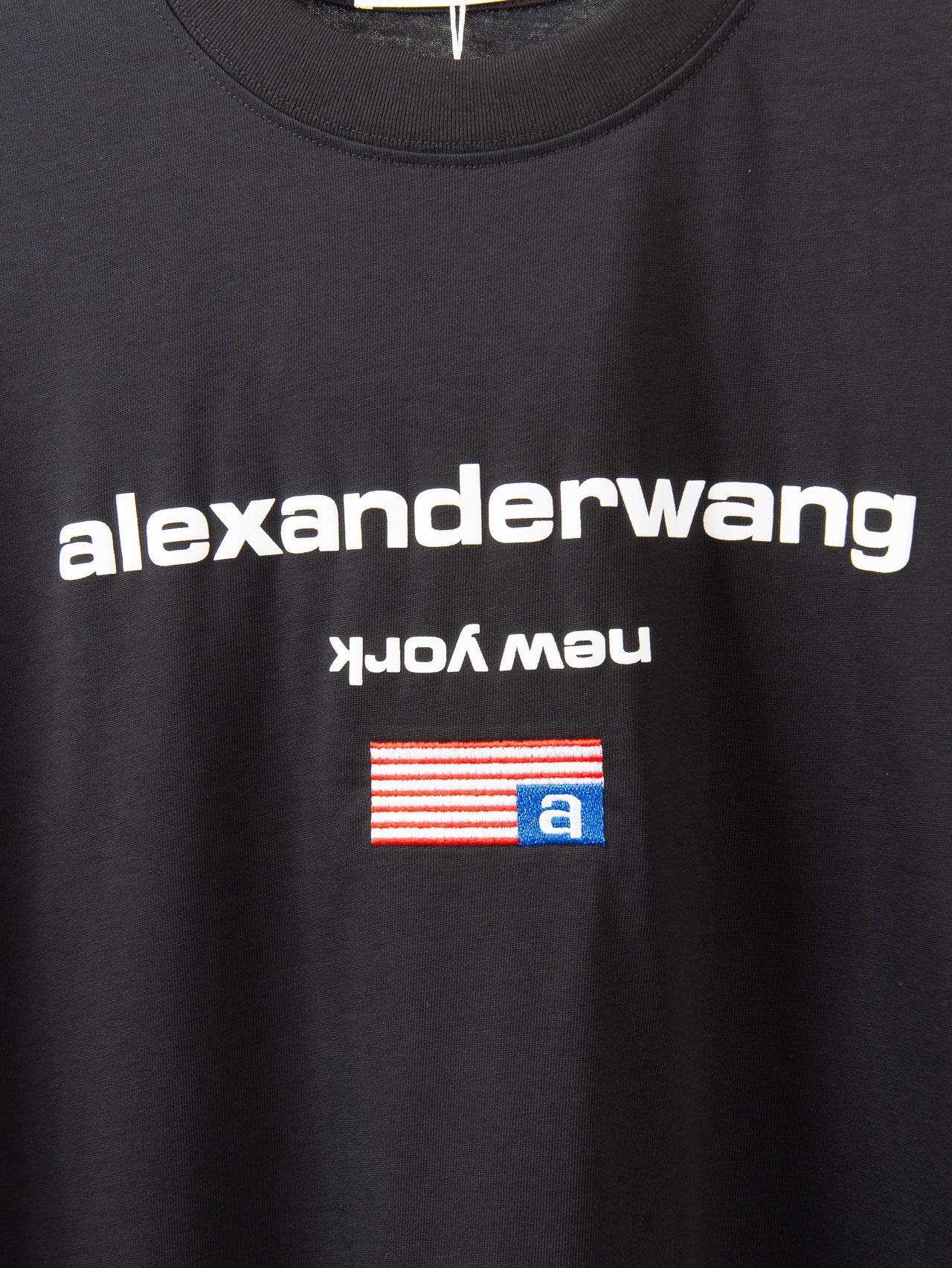 Black T-shirt chest graphic featuring alexanderwang text and flag-style logo