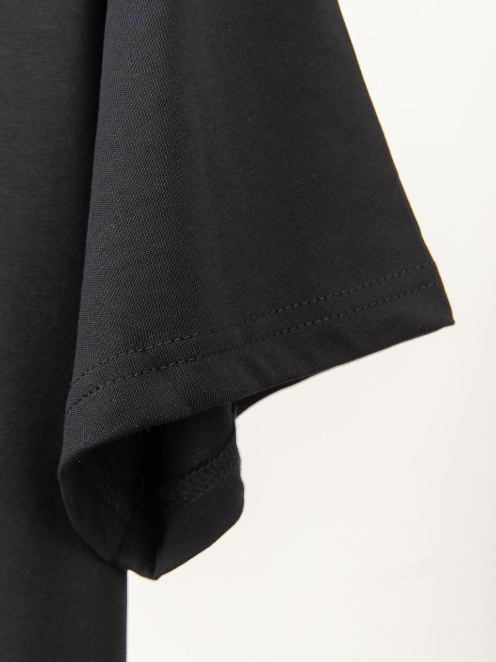Black T-shirt sleeve hem with neat stitching detail