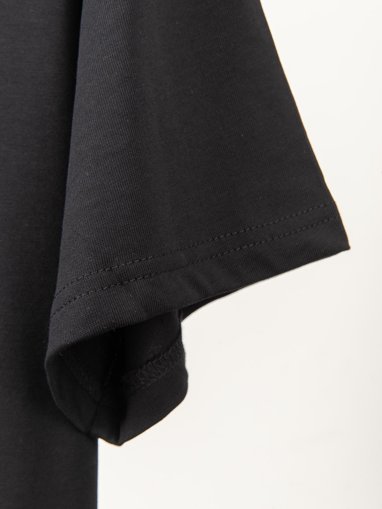 Black T-shirt sleeve hem with neat stitching detail