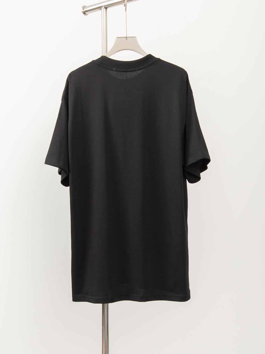 Black short-sleeve T-shirt, crew neck, plain back view on hanger