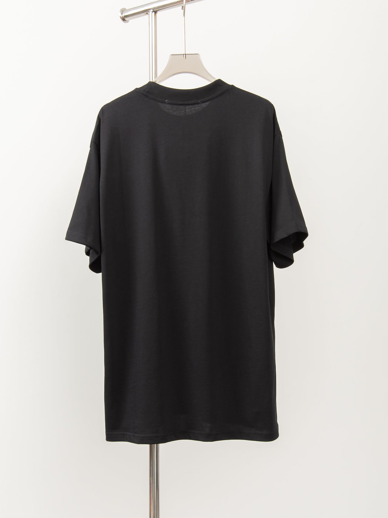 Black short-sleeve T-shirt, crew neck, plain back view on hanger