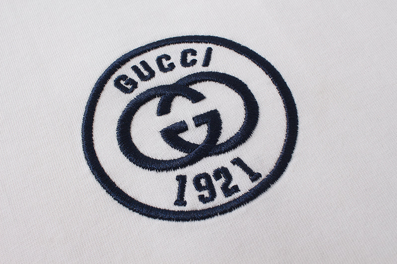 Gucci 1921 circular logo patch on white short-sleeve T-shirt