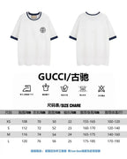 White short-sleeve T-shirt with navy trim, size chart listing sizes XS–L