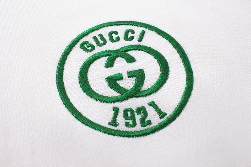 Gucci 1971 oval logo patch in green on white T-shirt