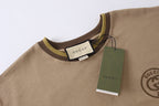 Tan Gucci T-shirt neckline with green tag and woven label at chest