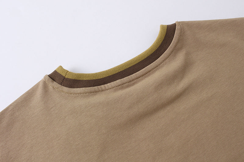 Tan short-sleeve T-shirt with ribbed crew neck and green trim detail