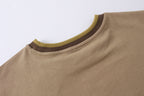 Tan short-sleeve T-shirt with ribbed crew neck and green trim detail