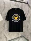 Black T-shirt with large round gold-and-white graphic on the chest