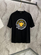 Black T-shirt with large round gold-and-white graphic on the chest