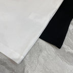 Versace T-shirt fabric close-up with white hem and black side beneath