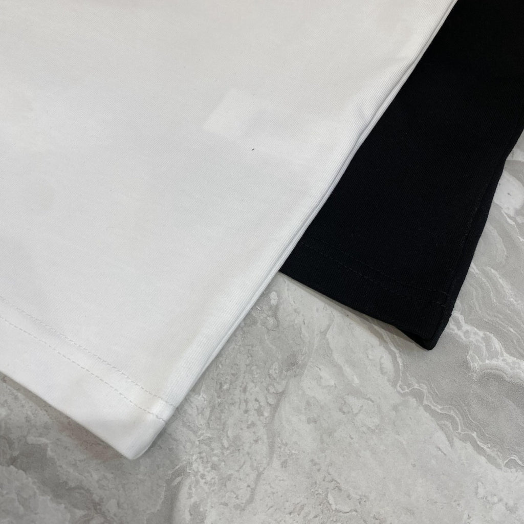 Close-up of white and black T-shirt fabric and side stitching