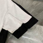 White and black Versace crewneck T-shirts laid flat, short sleeves