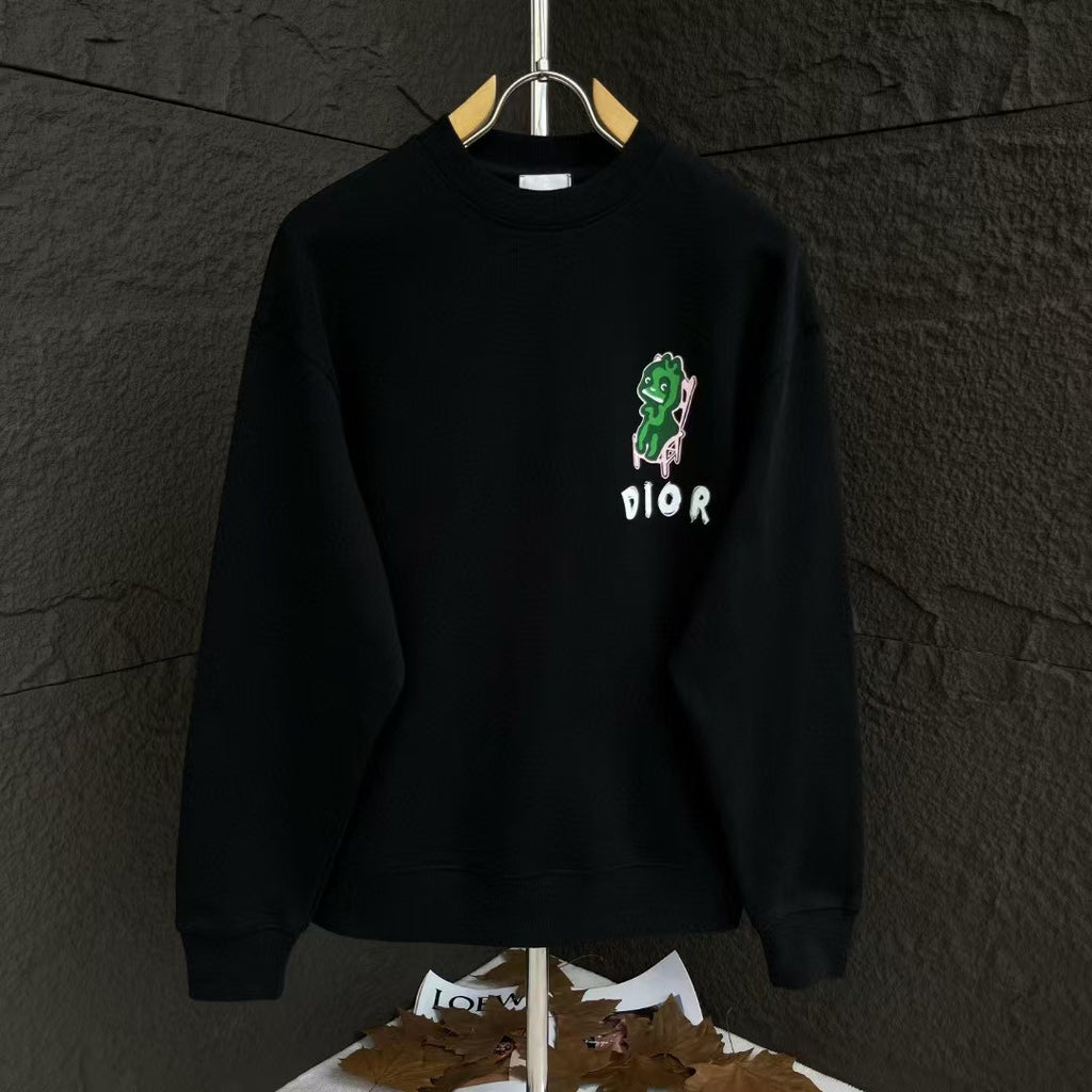 Black crewneck sweatshirt with green graphic and small DIOR logo on the chest.