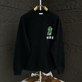 Black crewneck sweatshirt with green graphic and small DIOR logo on the chest.