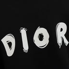 Black sweatshirt fabric with large white DIOR letter graphic across the front.