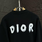 Black crewneck sweatshirt with large white DIOR text on the back.