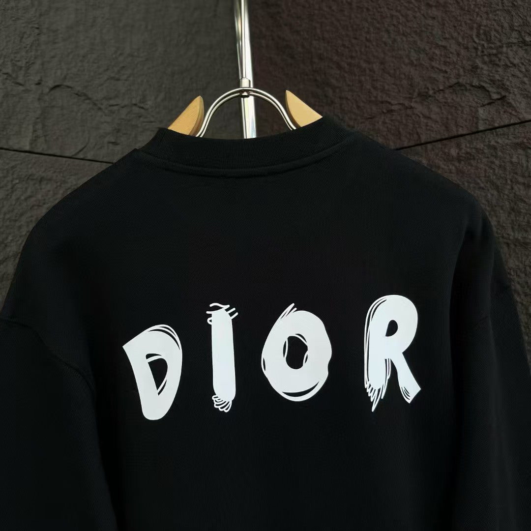 Black crewneck sweatshirt with large white DIOR text on the back.