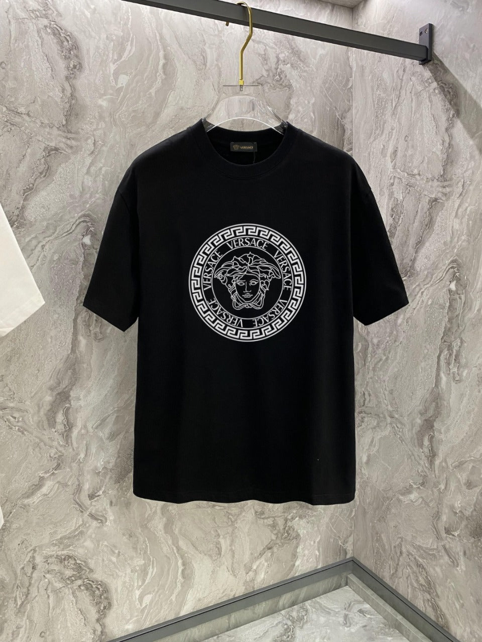 Versace black crewneck T-shirt with circular logo graphic on the front