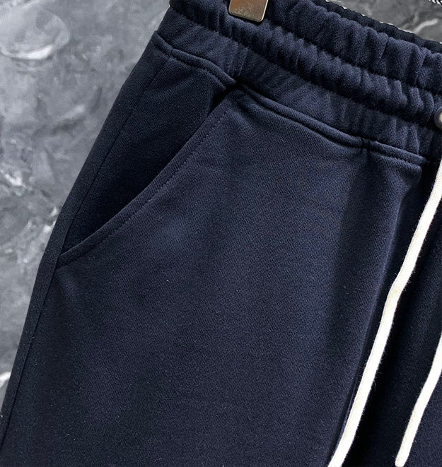 Dark navy sweatpants with elastic waistband and angled side seam