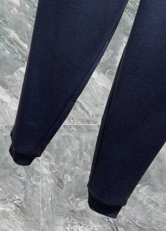 Navy track pants with tapered legs and elastic ankle cuffs