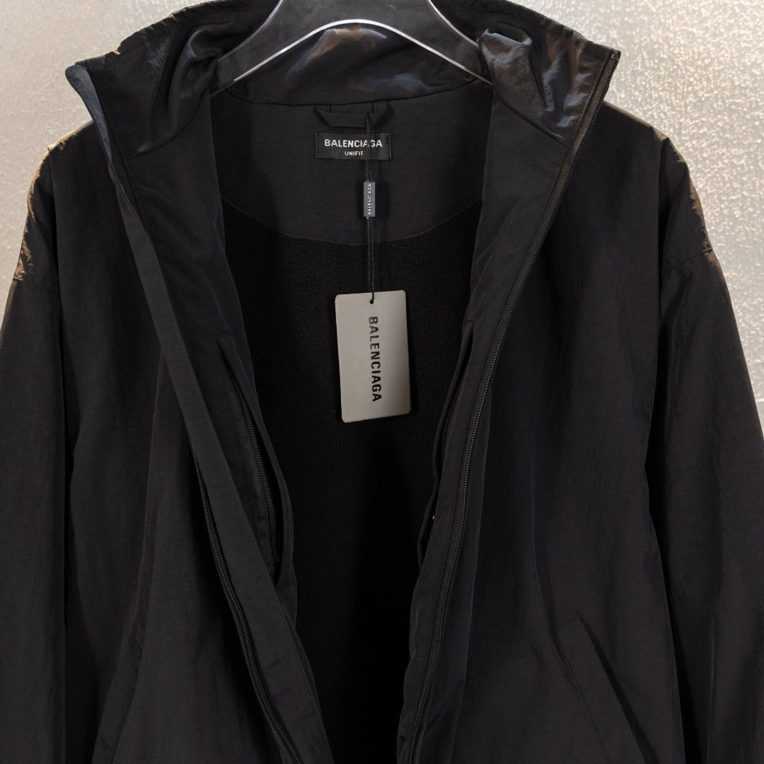 Black Balenciaga long jacket interior view with hood opening and tags