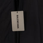 Black Balenciaga long jacket with hanging brand tag on zipper