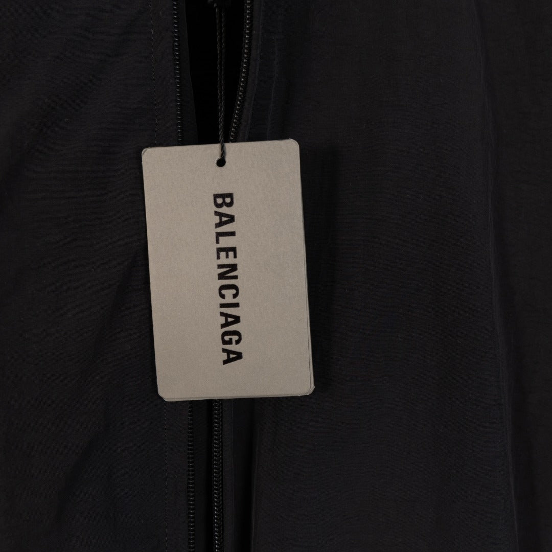 Black Balenciaga long jacket with hanging brand tag on zipper