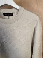 Cream crew-neck sweater close-up, textured knit front panel