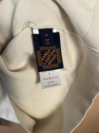 Cream sweater care label and size tag inside neckline