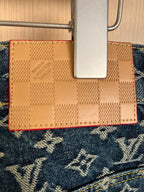 Louis Vuitton monogram denim inner pocket with tan leather-like label