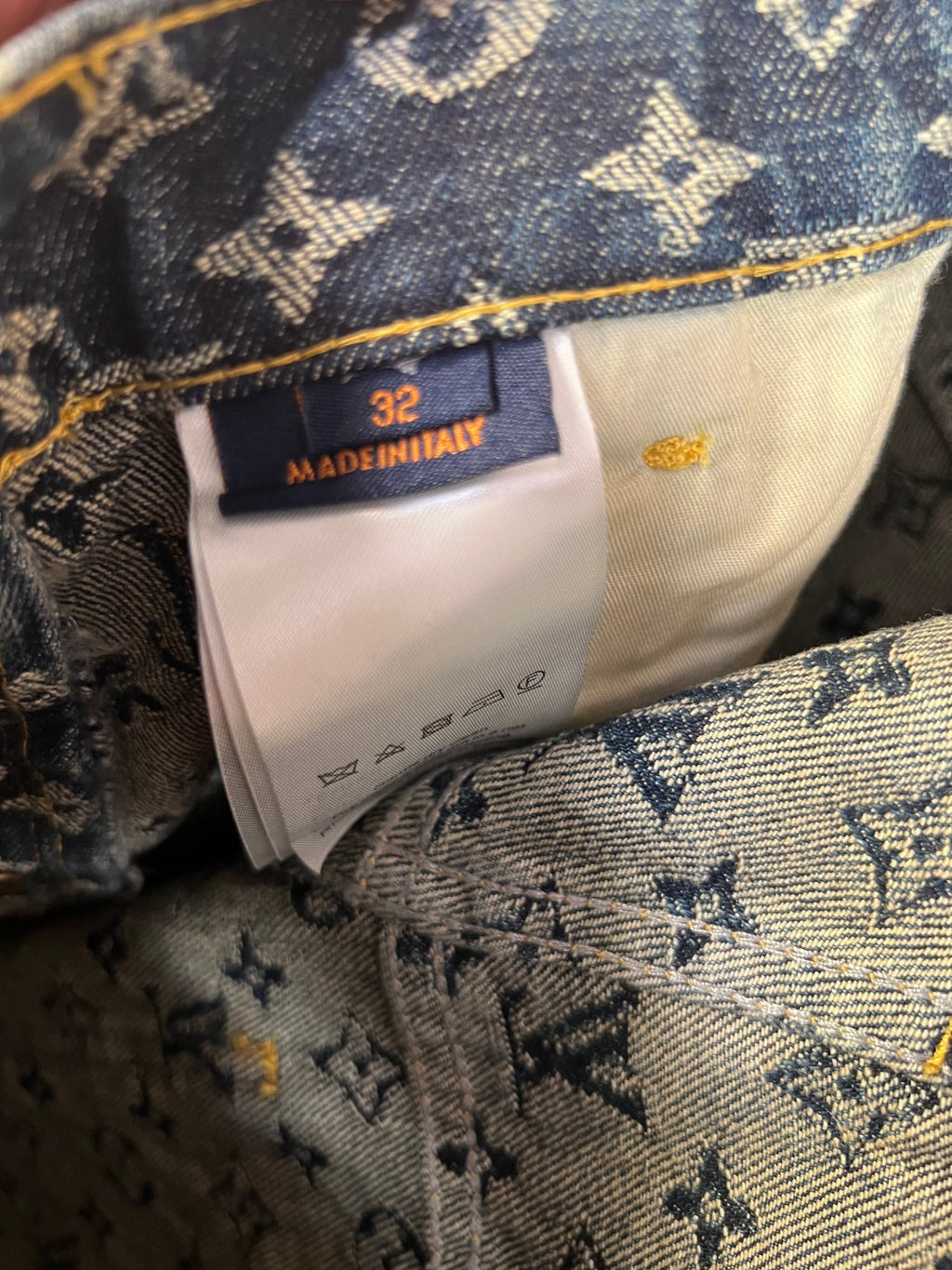 Louis Vuitton denim size tag reading 32, Made in Italy on monogram lining