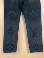 Dark denim pants with all-over monogram motifs on both legs