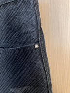 Dark denim pants with front pocket seam and small metal button detail