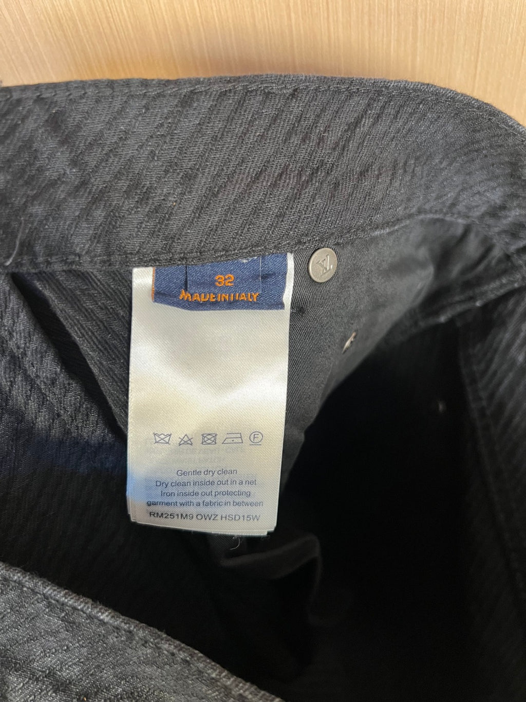 Inside care label on dark denim pants waistband