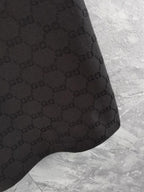 Gucci polo shirt hem, black with textured interlocking pattern