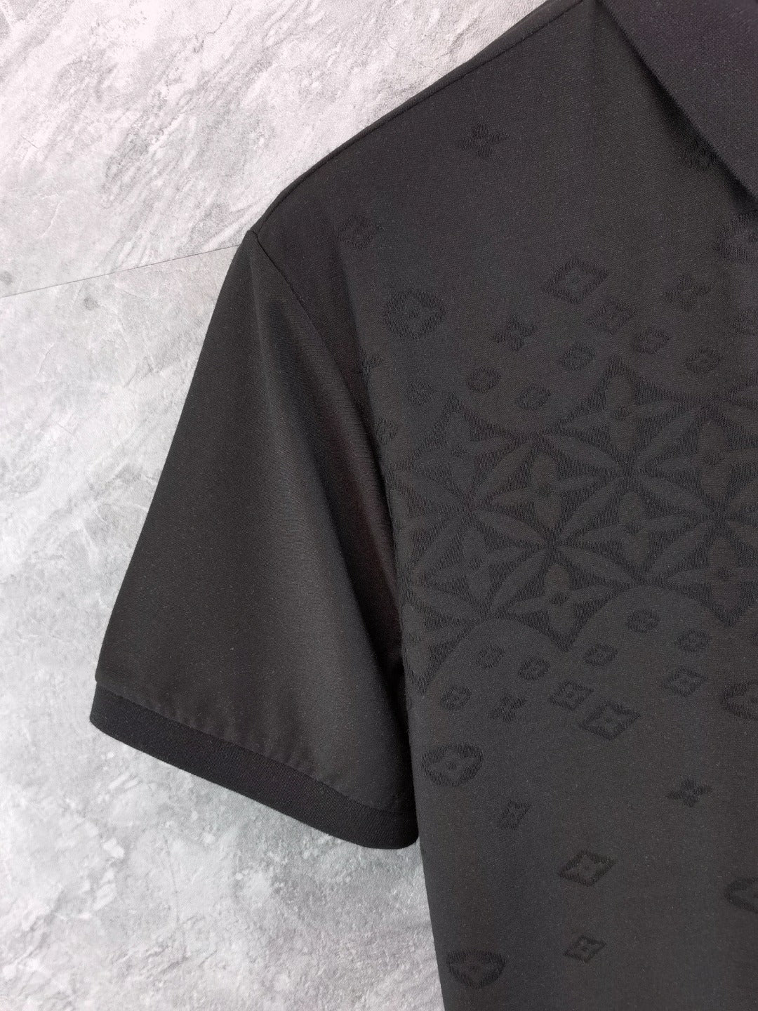 Louis Vuitton black polo shirt side view with short sleeve and textured monogram