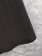 Louis Vuitton black polo shirt fabric close-up with subtle repeating pattern