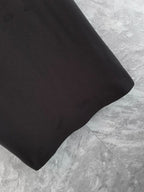 Black polo shirt lower hem and sleeve seam detail