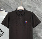 Black polo shirt close-up with collar, button placket, and chest logo patch