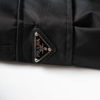 Prada triangle logo patch on black cargo pants pocket