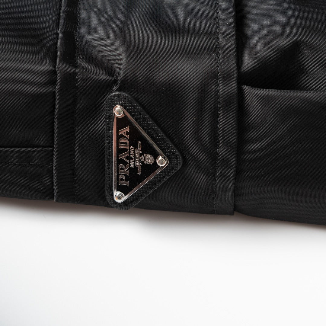 Prada triangle logo patch on black cargo pants pocket