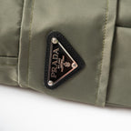 Olive Prada cargo shorts with triangular Prada logo patch on pocket
