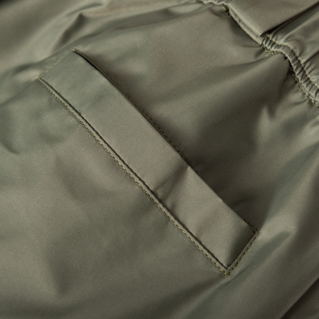 Olive Prada cargo shorts with angled seam and stitched zipper fly