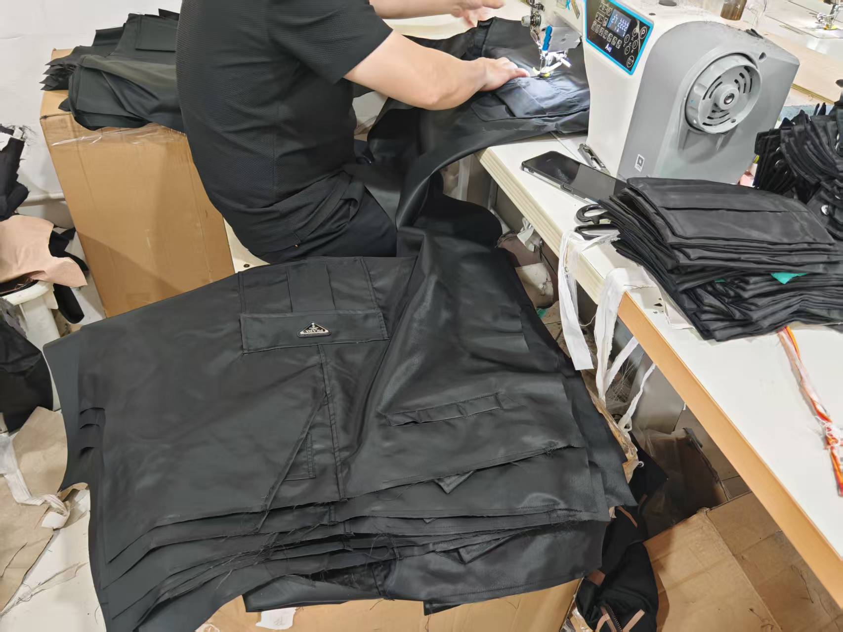 Black cargo pants with multiple pockets, laid out