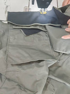Light gray cargo pants with side pockets and stitched seams