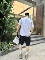 Black knee-length shorts on model, back view